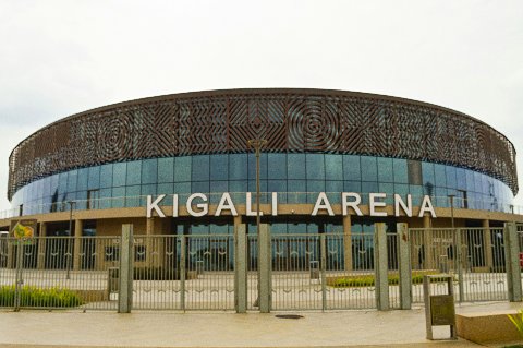 Front facade of Kigali Arena with decorative frieze and gated entrance, a modern Rwanda landmark
