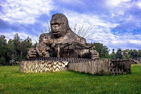 Giant gorilla sculpture cradling a baby at an outdoor exhibit symbolizing Rwanda's mountain gorilla heritage
