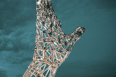 Illuminated lattice hand sculpture above the Kigali Convention Centre entrance at dusk in Rwanda