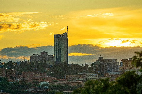 Kigali skyline at golden sunset with a prominent tower rising above the city hills in Rwanda